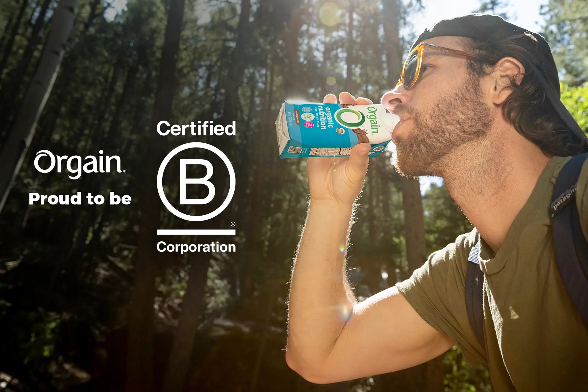 Man drinking water with B corp logo next to him