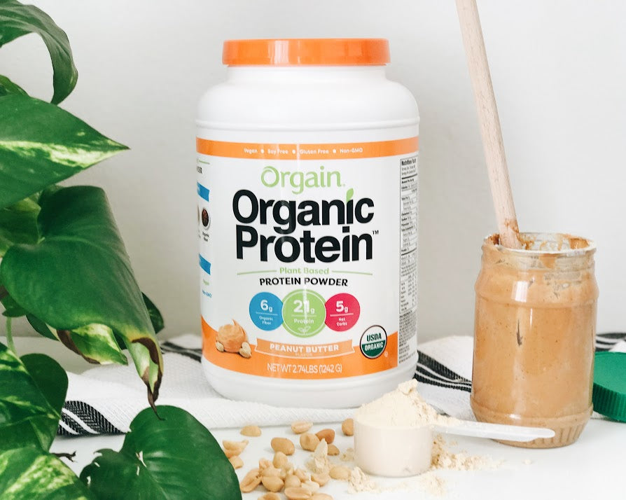 orgain peanut butter protein powder next to a jar of peanut butter