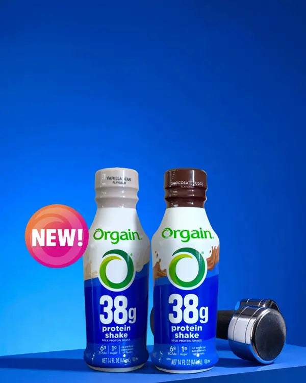 Two bottles of Orgain protein shake with a blue background