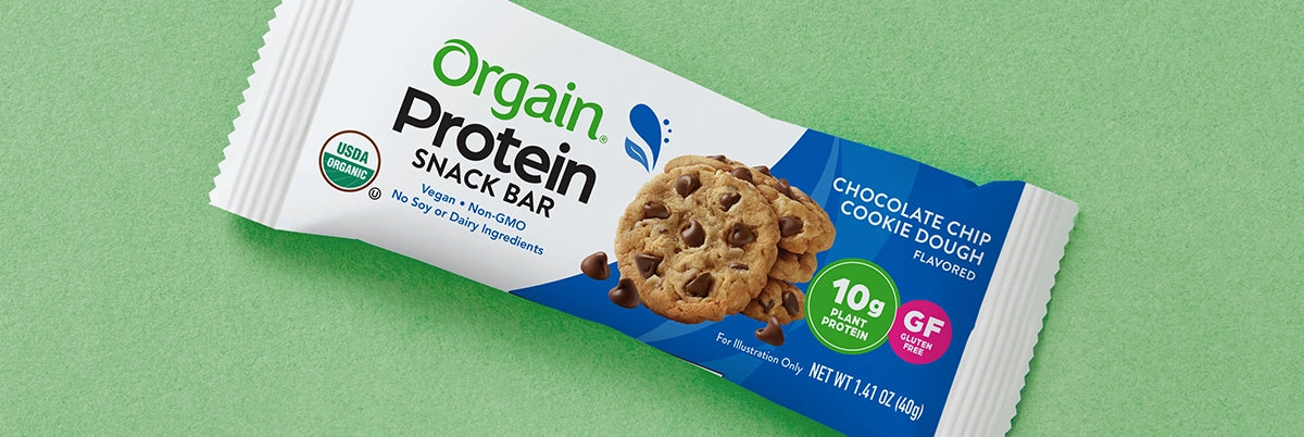 organic chocolate chip cookie dough protein bar on a green background