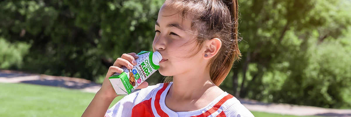Girl drinking an orgain kids shake