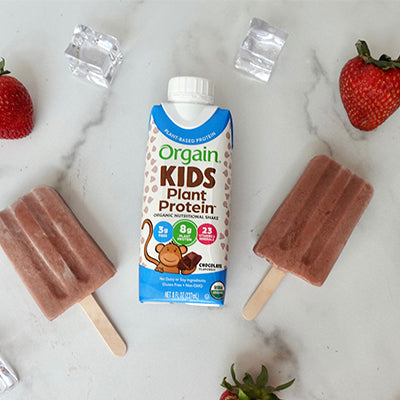 Orgain Kids Chocolate shake next to protein popsicles