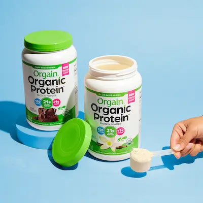 orgain protein powder on a light blue background