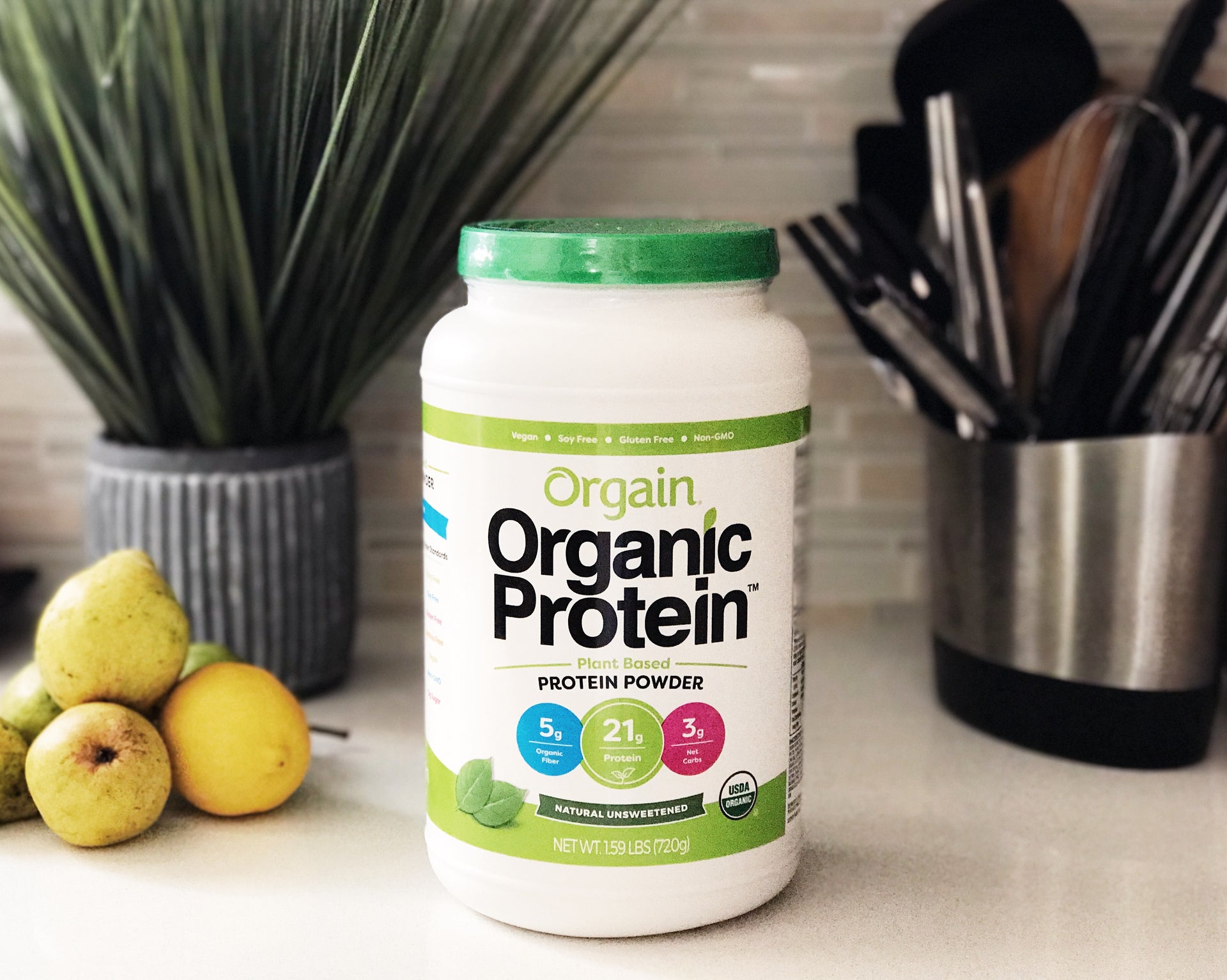 A tub of Orgain's Organic Protein powder sitting on a kitchen counter