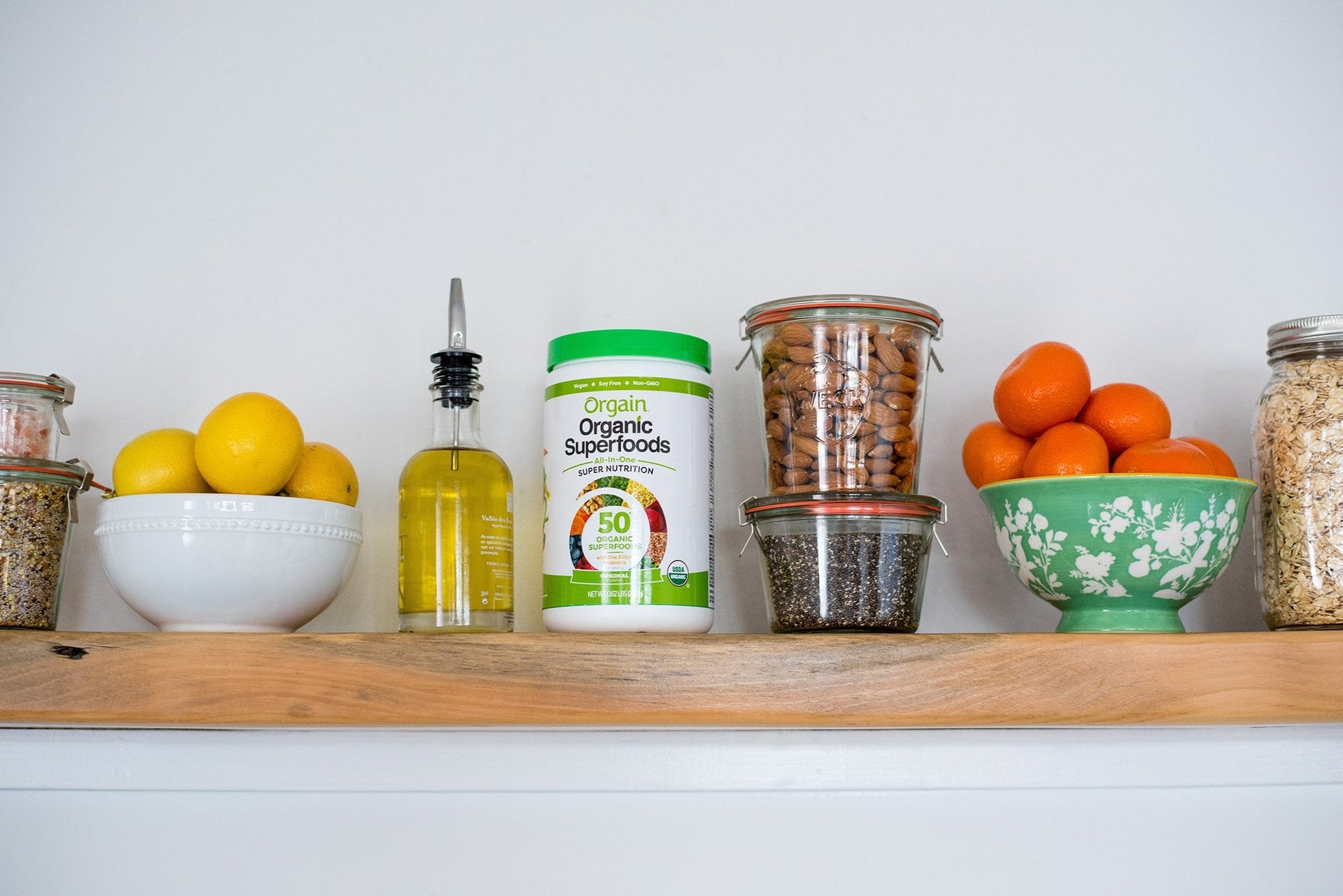 A kitchen shelf featuring Orgain's Organic Superfoods among other dish ingredients.