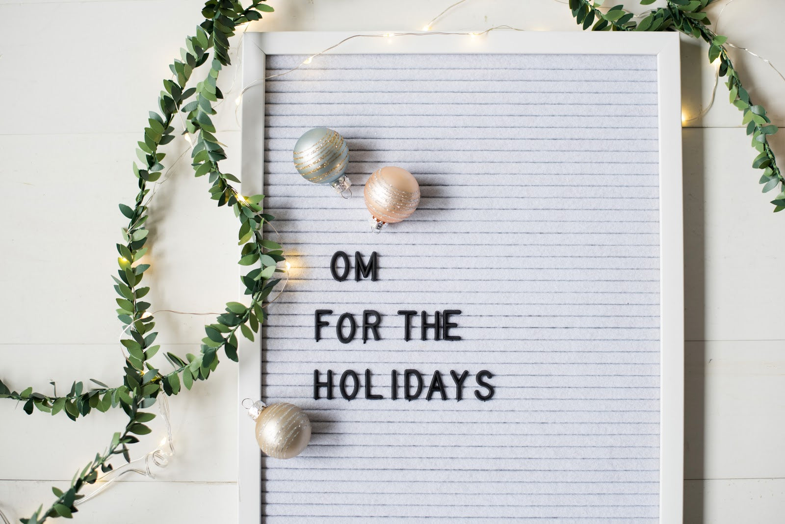 A festive letterboard that reads "Om for the holidays".