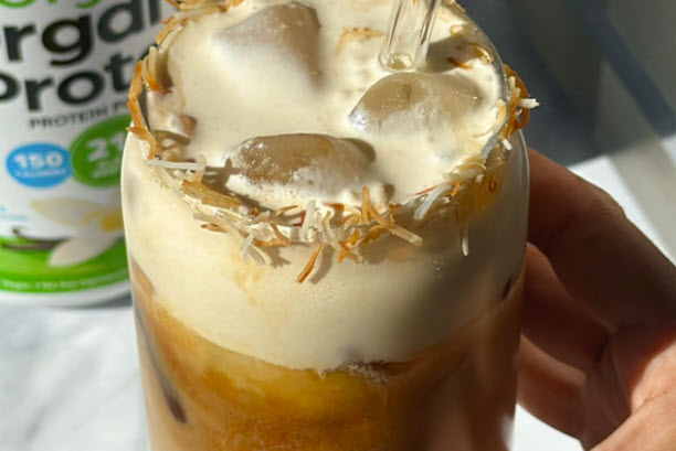 Coconut latte with toasted coconut rim and vanilla protein cold foam