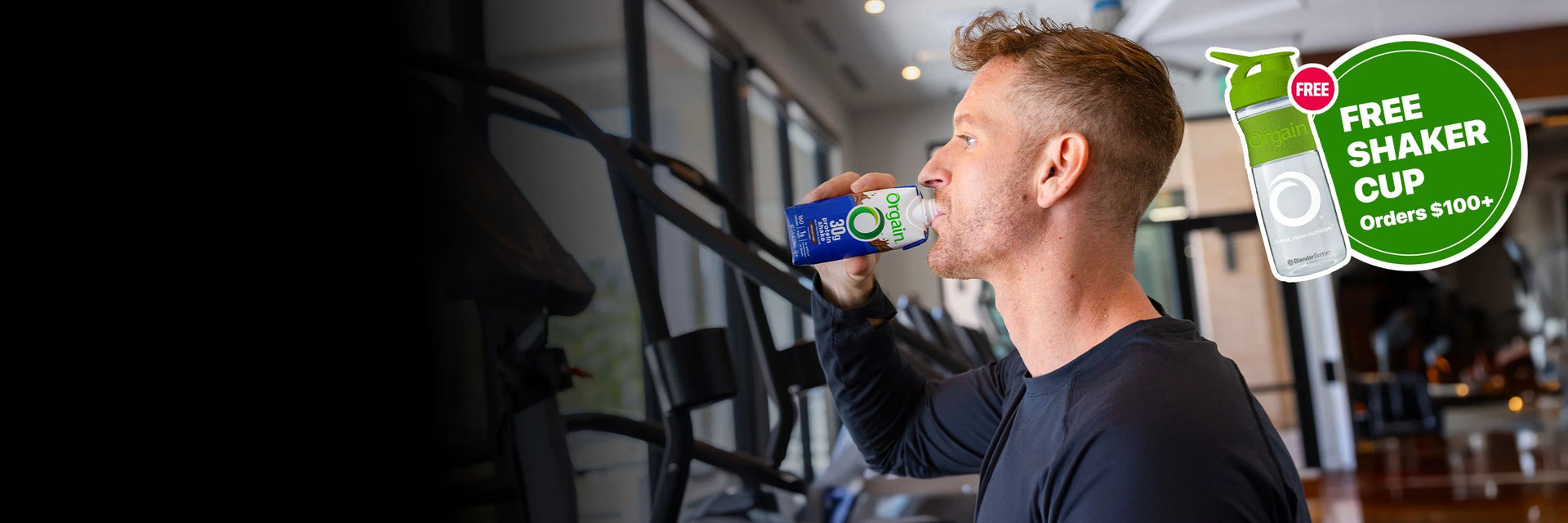 Man drinking 30g protein shake while walking on the treadmill + label advertising free shaker cups on orders $100+