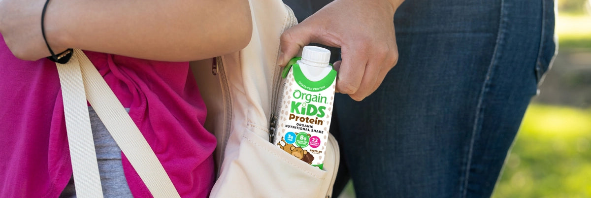 Orgain Kids organic shake being added to kids backpack