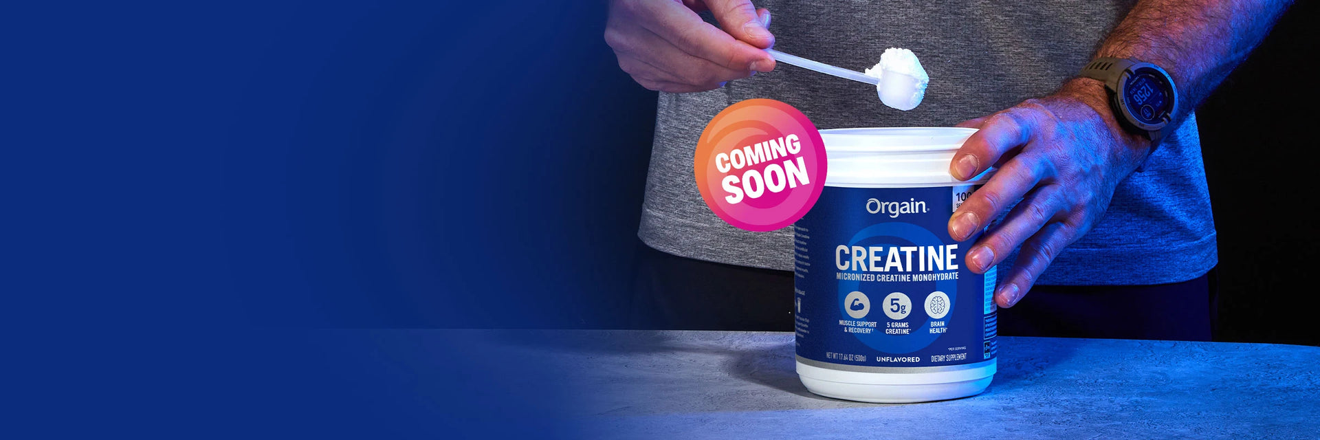 person scooping creatine out of container with a coming soon label