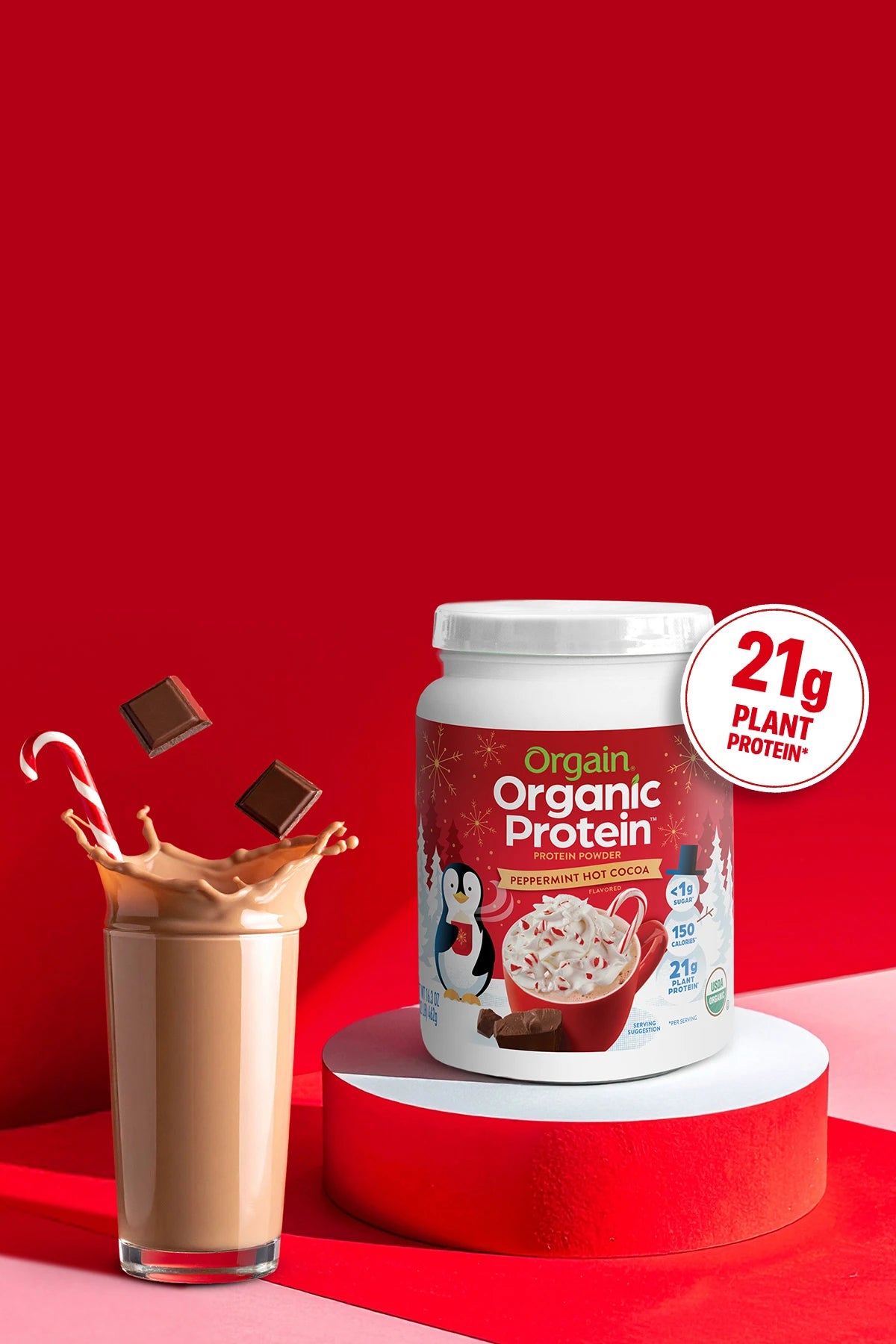 Organic Protein container with a glass of chocolate protein shake on a red background