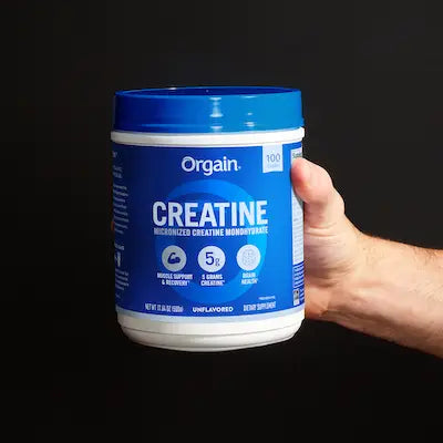 orgain micronized creatine powder on a black background