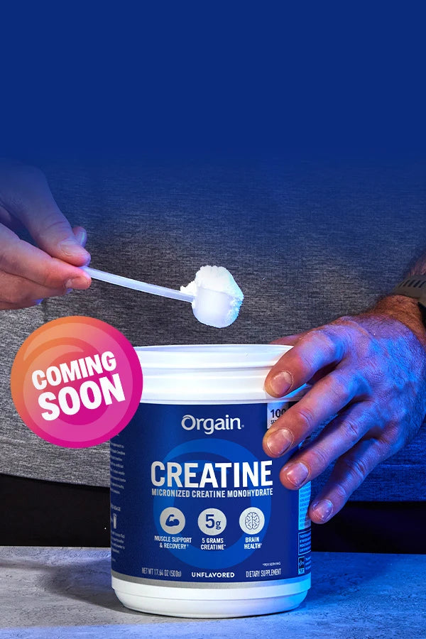 person scooping creatine out of container with a coming soon label